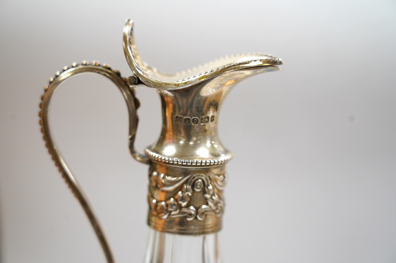 A modern silver mounted pepper mill, London, 1973, 86mm and a Victorian silver mounted glass vinegar bottle. Condition - poor to fair